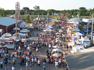 Aerial view of people walking along the Cowley County Fair midway