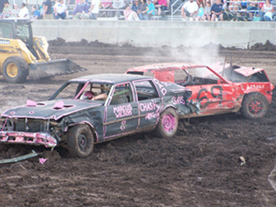 Black and red car hitting each other at demo derby
