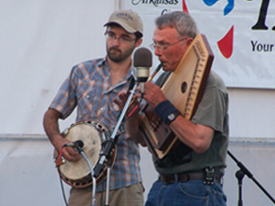 Musicians playing a banjo and autoharp